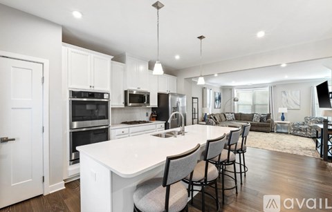 A modern kitchen with white cabinets and a large island.