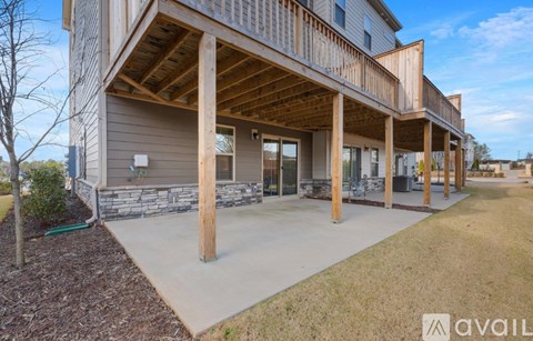 A modern house with a large front porch and a covered walkway.