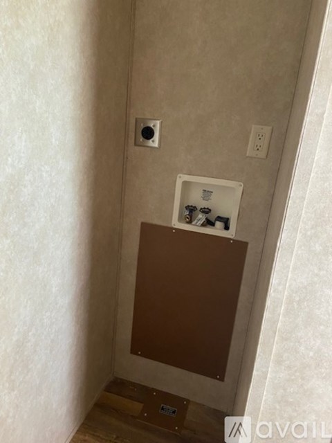 A bathroom with a brown cabinet and a white box on top of it.