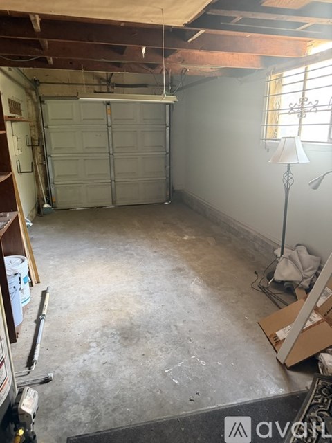 A room with a garage door and a window.