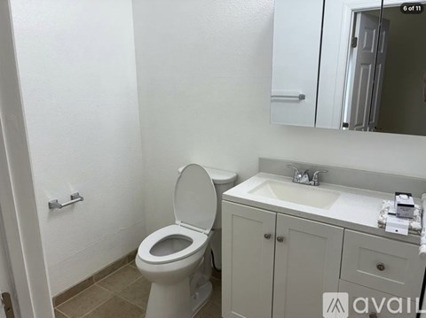 A white toilet and sink in a bathroom.