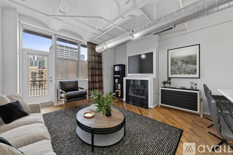 A living room with a couch, chair, and television.