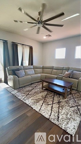A living room with a large sectional sofa and a coffee table.