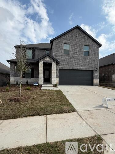 A modern house with a grey exterior and a black garage door.