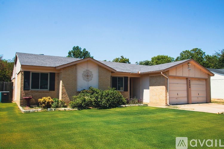 A house with a lawn in front of it.