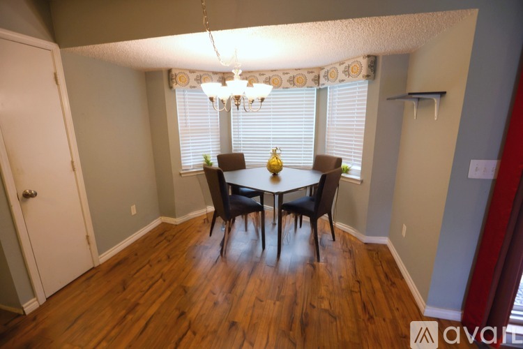A dining room with a wooden table and chairs.