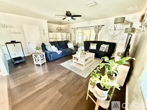 A living room with a blue couch and a white coffee table.