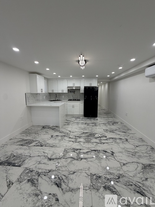 A spacious kitchen with marble flooring and a modern design.