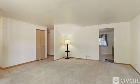 A room with a lamp and a door.