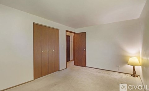 A room with a lamp and two doors.