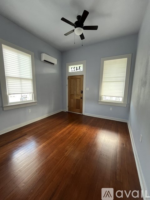 A room with a wooden floor and a ceiling fan.