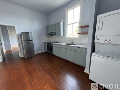 A kitchen with a white fridge, oven, and microwave.