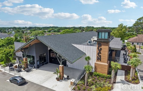 A modern building with a watchtower-like structure on top.
