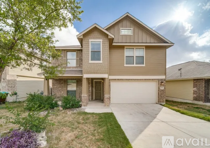 A house with a garage and a driveway is for sale.