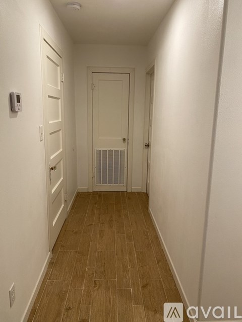 A long hallway with a door at the end.