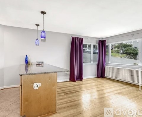 A room with a wooden cabinet and purple curtains.