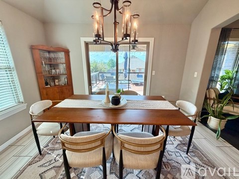 A dining room with a wooden table and chairs.
