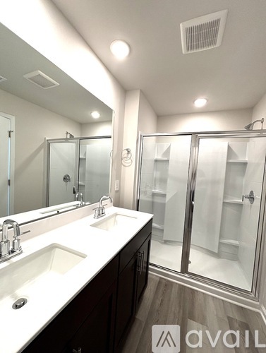 A bathroom with a white sink and a mirror.