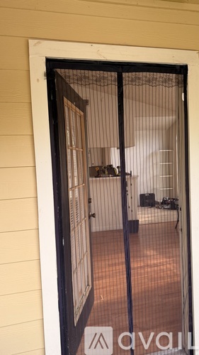 A black gate with a sign that says "available" is open.