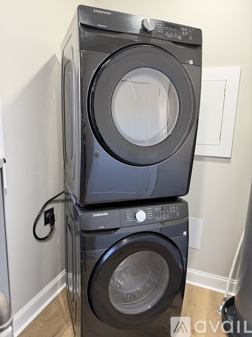 A Samsung front load washer and dryer stacked on top of each other.