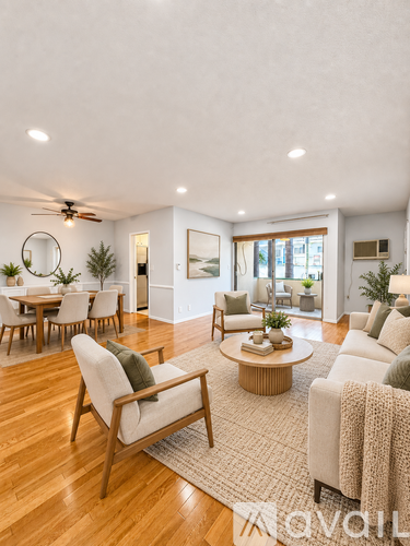 A living room with a wooden floor and furniture.