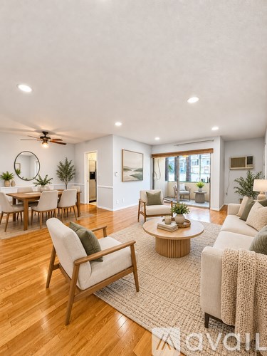 A living room with a wooden floor and furniture.