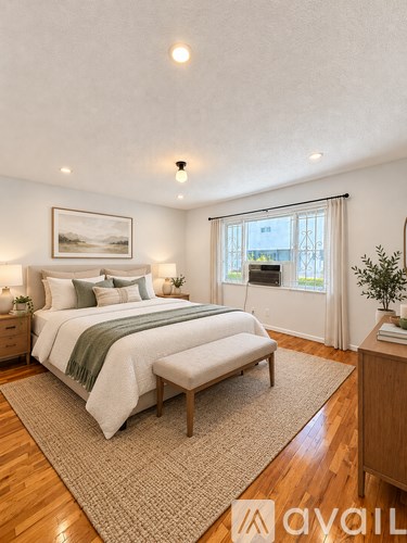 A bedroom with a large bed and a window overlooking a cityscape.