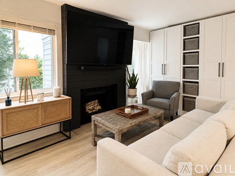 A living room with a fireplace, a television, and a couch.