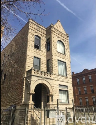 A tall building with a brick facade and a large arched entrance.
