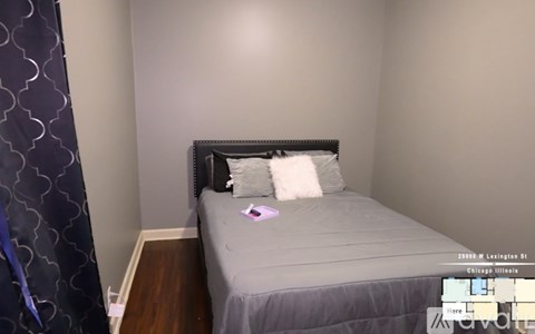 A bedroom with a bed and a pillow on it.
