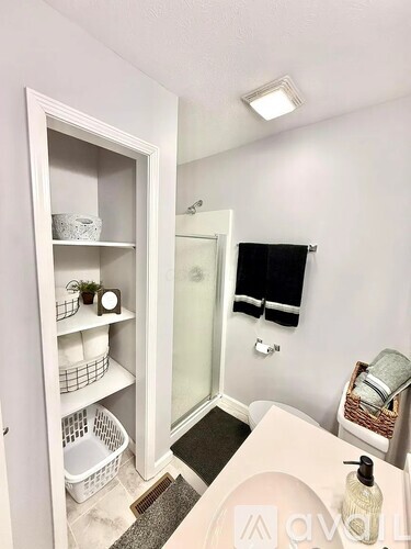 A white bathroom with a white sink and a white cabinet.