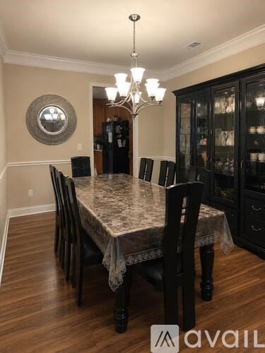A dining room with a table set for six.