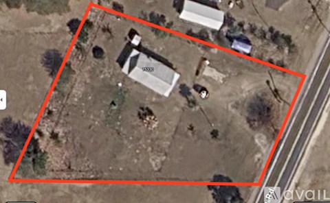 A satellite image shows a property with a house and a car.