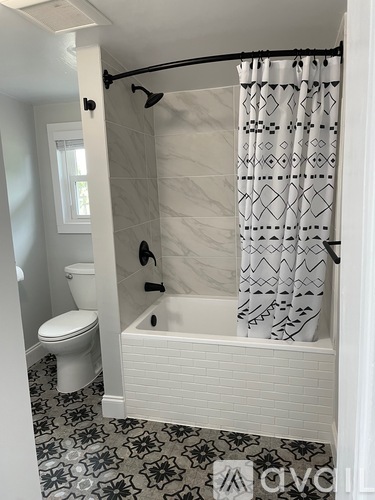 A white bathroom with a black and white floor.