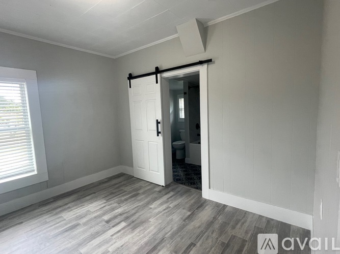 A room with a sliding door leading to a bathroom.