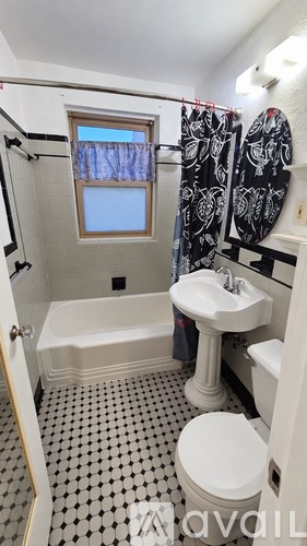 A bathroom with a toilet, sink, and bathtub.