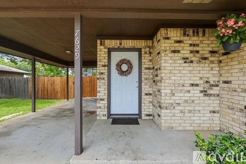 A white door with a wreath on it is the main focus of the image.