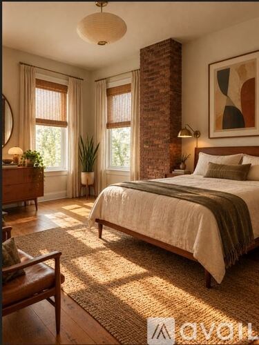 A bedroom with a large bed and a wooden floor.