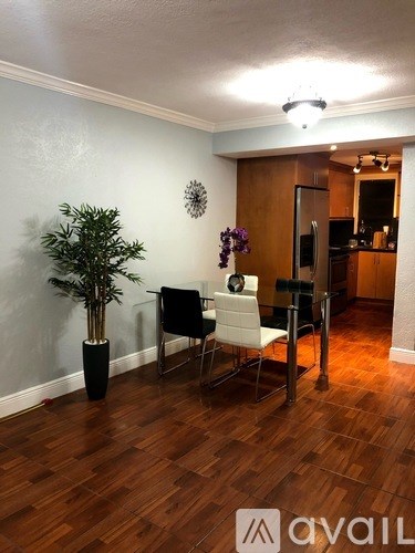 A room with wooden floors and a white chair.