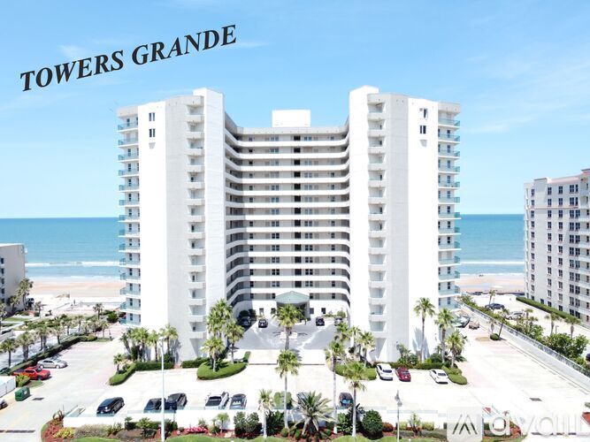 A large white building with the words "TOWERS GRANDE" on top of it.