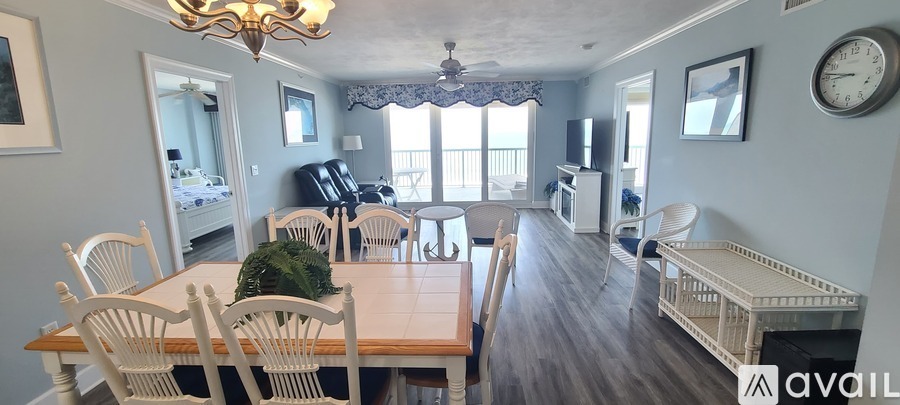 A dining room with a wooden table and chairs.