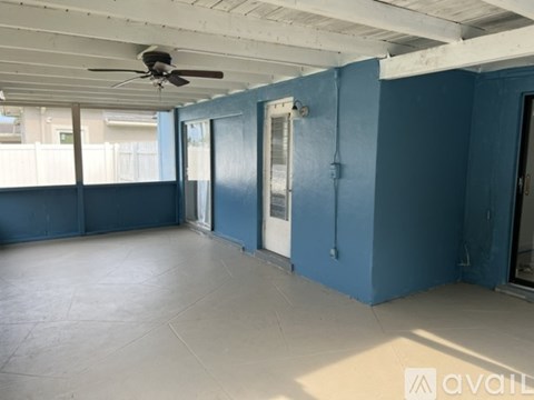 A room with blue walls and a ceiling fan.