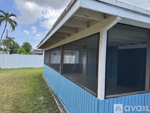 A blue building with a white roof and a sign that says "available" on the side.
