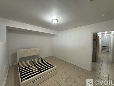 A bedroom with a bed and a tiled floor.