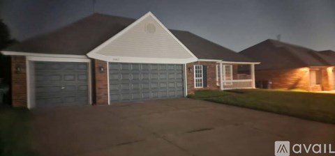 A house with a lit up garage door.
