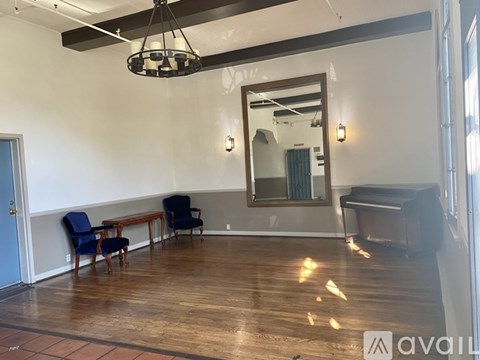 A room with a piano and a mirror on the wall.