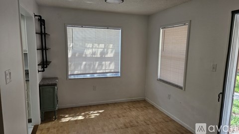 A room with a window and a door.