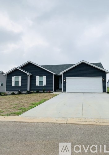 A two-story house with a garage is available for sale.