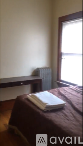 A bed with a white pillow on it in a room.