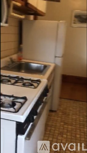 A kitchen with a white stove and sink.